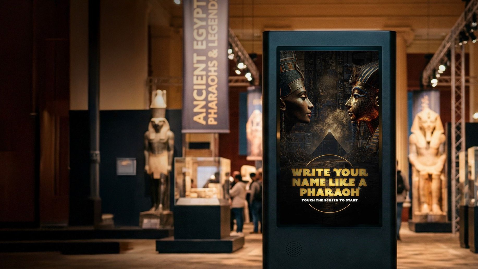 A large-format touchscreen kiosk in the PBS Ancient Egypt exhibition showing the Write Your Name Like a Pharaoh attract screen