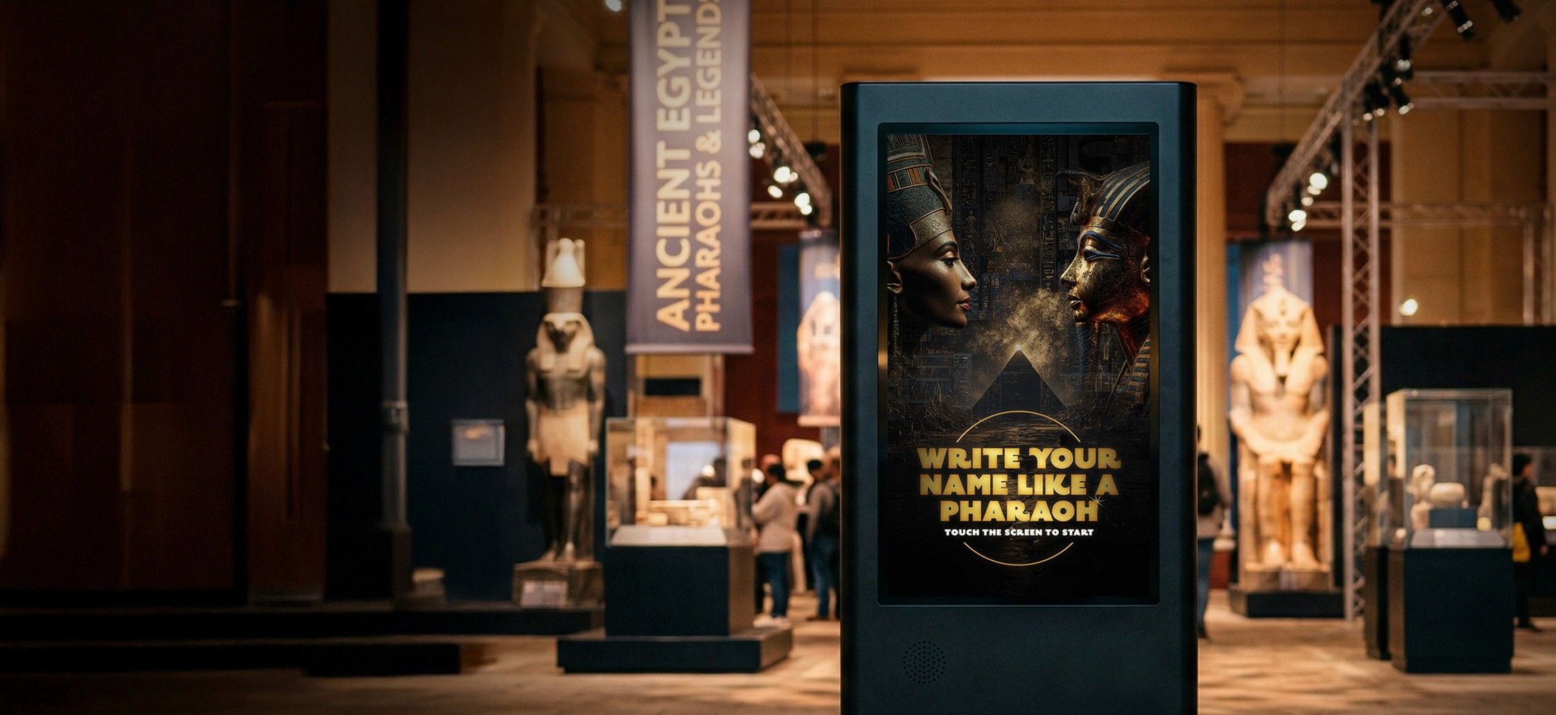 A large-format touchscreen kiosk in the PBS Ancient Egypt exhibition showing the Write Your Name Like a Pharaoh attract screen